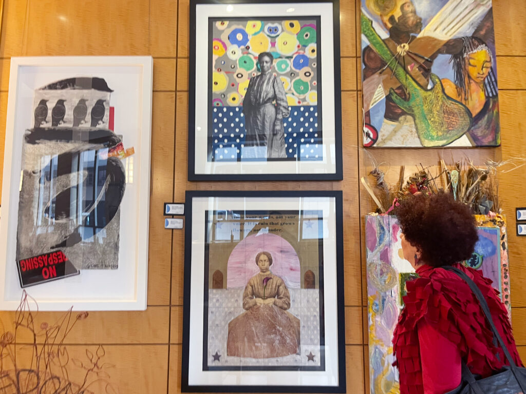 Margery Goldberg looks over work by Curtis Woody.