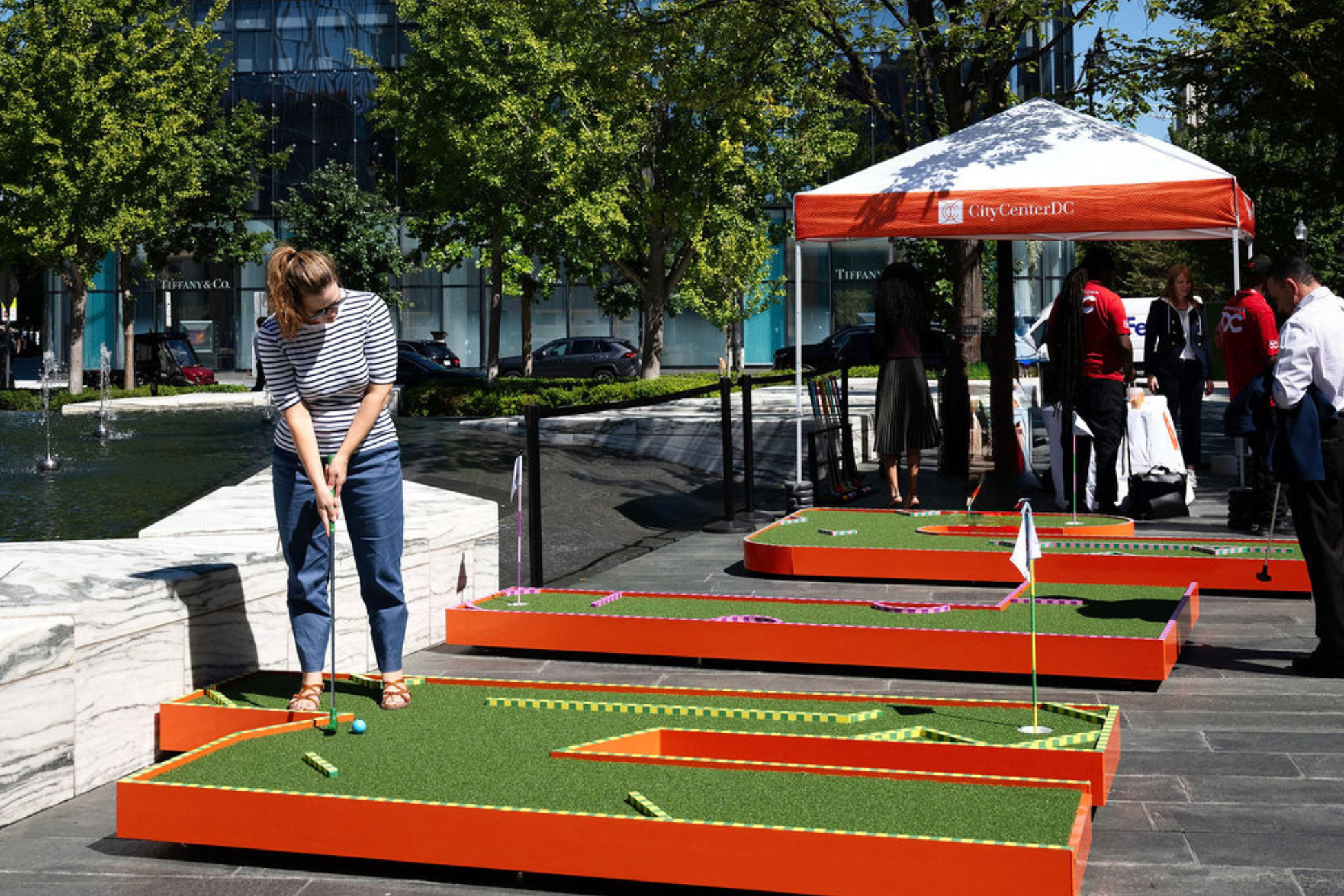 putt-in-the-park-offive worker is playing on a mini golf course in the city