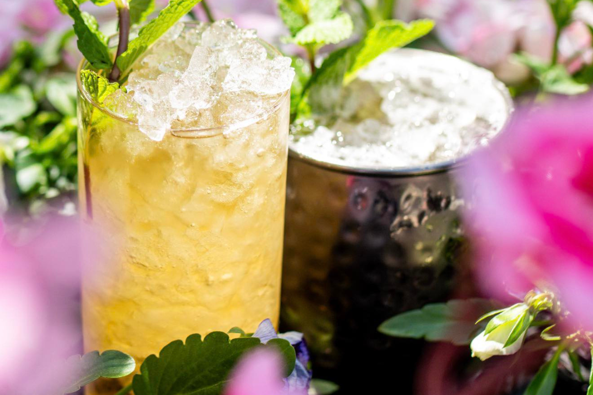 after-dark-at-the-tikki-affair yellow, tropical cocktail drink with floral background.